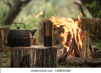 camping items by the fire kettle with thermos, travel concept and Hobbies - Powered by Shutterstock