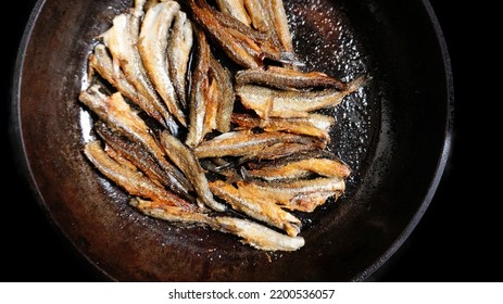 Camping Kitchen And Cooking In The Field. Cast-iron Pan For A Fire And Fried Small Fish (anchovy, Smelt, Sprat). Second Dish