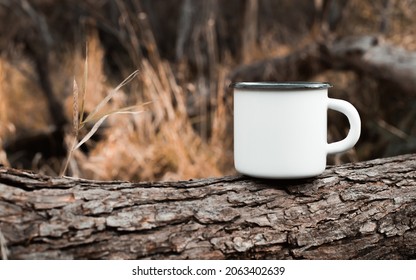 Camping Metal White Mug Mockup Standing On Tree In Forest Outdoors, Copy Space For Text. Enamelled Empty Cup For Branding Or Logo.