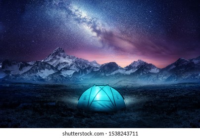 Camping in the mountains under the stars. A tent pitched up and glowing under the milky way. Photo composite. - Shutterstock ID 1538243711