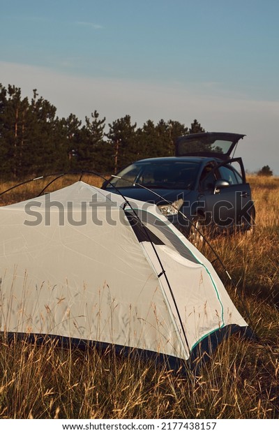 Camping in nature, unpacking and packing\
small tent outdoors, recreation and\
hobbies.