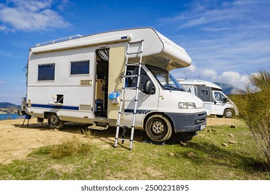 Camping on nature. Camper vehicle with portable ladder. Caravanning equipment, must have tool, maintain rv. Holiday trip with motor home.