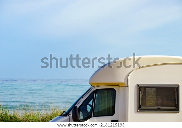 Camping on sea shore. Camper vehicle on beach,\
mediterranean coast in\
Spain.