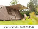 Camping picnic green tent campground in outdoor park lake. Camper while campsite in mountain and lake nature background at summer trip camp. Adventure Travel and Vacation concept