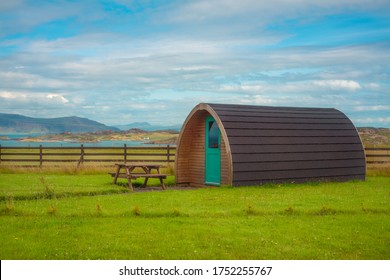 Camping Pod And Picnic Table In A Grassy Field At A Campsite By The Sea In Scotland