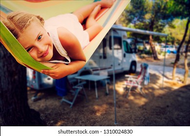 Camping RV travel with camper, summer beach. Happy smiling beauty girl on mototorhome vacation.