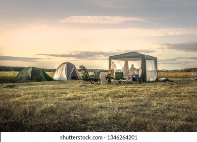 Camping Site Camping Tents On Summer Field Sunset Sky During Camping Holidays