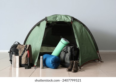 Camping tent with different hiking equipment indoors