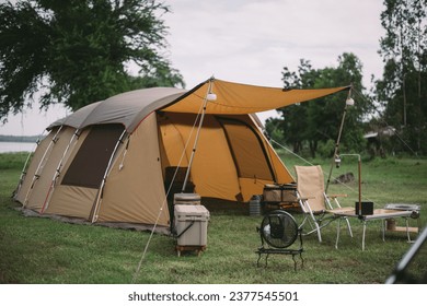 Camping tent in a camping in a forest by the river - Powered by Shutterstock