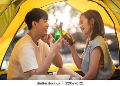 Camping Tent With Friends, Asian Young Family Hangout Together And Drinking Alcohol Beverage Inside A Tent, Outdoor Activity And Leisure On Holiday.