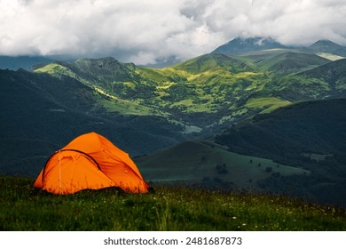 Camping tent high in the mountains. Hiking tour or wild camping and travel concept