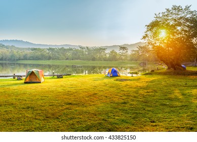 Camping And Tent Near Lake In Sunrise