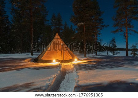 Camping in a Tipi in Lapland in snow at night