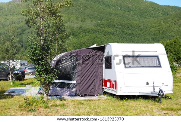 camping trailer on a background
of mountain nature, the theme of rest with family and
relaxation
