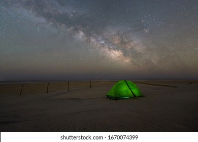 Camping under the Milky Way Galaxy and stars on a beach at Assateague Island in Maryland 