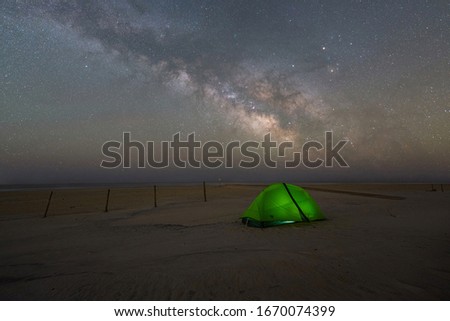 Camping under the Milky Way Galaxy and stars on a beach at Assateague Island in Maryland 