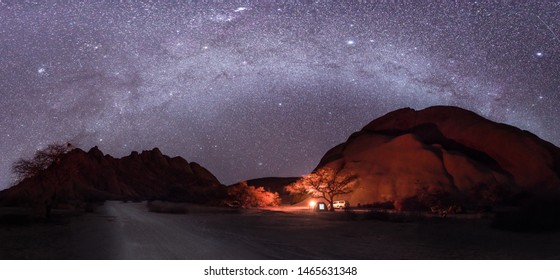 Camping Under The Milky Way Stars With A Camp Fire In Spitzkoppe, Namibia