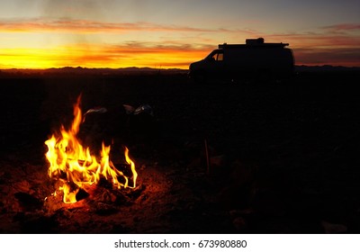 Camping Van silhouette with Campfire and Sunset