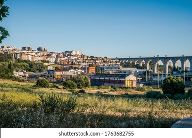 Campolide PORTUGAL - 23 May 2020 - Sunset In Cityscape Overlooking The CP Station And Águas Livres Aqueduct