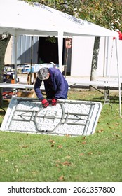 Campsegret, Dordogne. France. October, 16th 2021. Women At Work, Putting Up A Table For Fundraising Event.