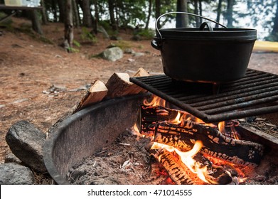 Campsite With A Dutch Oven Cooking Over A Fire Ring