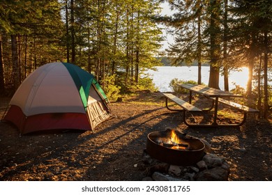 Campsite on lake in northern Minnesota with campfire at sunset - Powered by Shutterstock