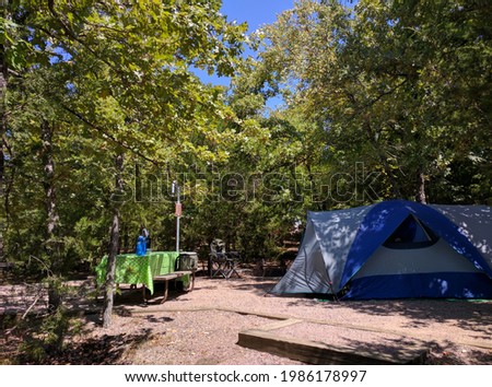Campsite with tent, table and firering