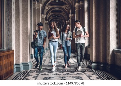 Campus Life Is Awesome!Group Of Students Are Walking In University Hall And Chatting.