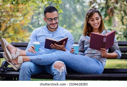 Campus life, student's love. Young couple learning together in the park. Education, love and tenderness, dating, romance, lifestyle concept