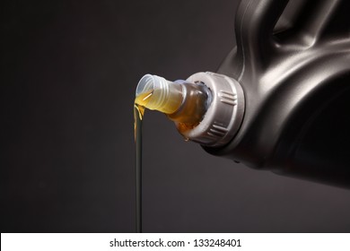 Can With Car Engine Oil Pouring In Front Black Background