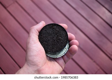 Can Of Chewing Tobacco Held In A Hand