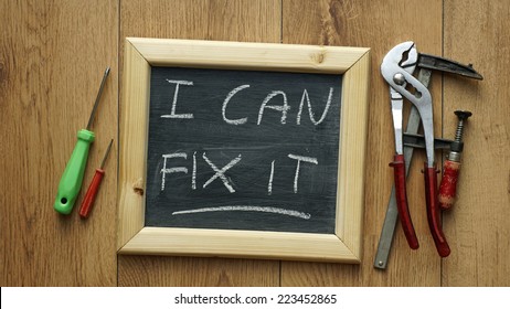 I can fix it written on a chalkboard with tools next to it