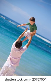 I Can Fly. Happy father and son on the beach.