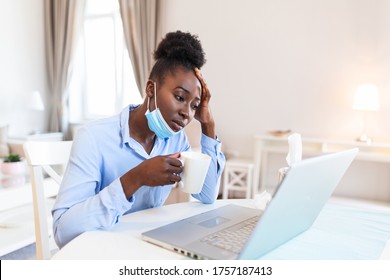 I Can Not Believe I Caught A Cold! Frustrated African American Businesswoman Drinking Hot Beverage With Protective Mask. It's Flu Season. Sick Young Business Woman At Work