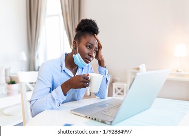 I Can Not Believe I Caught A Cold! Frustrated African American Businesswoman Drinking Hot Beverage With Protective Mask. It's Flu Season. Sick Young Business Woman At Work