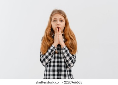 I Can Not Believe It. Portrait Of Surprised, Shocked Teen Girl Looking At Camera With Amazed Face, Grab Face Scream Impressed Breaking News, Standing In Casual Shirt Over White Background