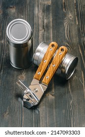 Can Opener And Two Tin Cans On Table