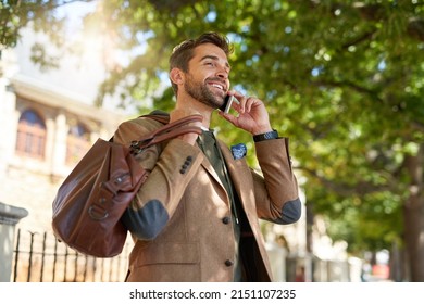 I Can See Your Building. Cropped Shot Of A Handsome Young Man Making A Phonecall During His Morning Commute.