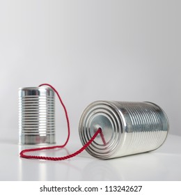 Can telephone with red wire. Conceptual communication image.