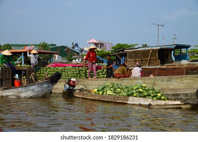 CAN THO, VIETNAM - Mar 19, 2014: Vendors at the floating market, in Can Tho, Vietnam, on the Mekong Delta, loading water melons on to a smaller boat from a larger boat.