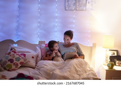 Can we read another one, Mom. Cropped shot of an attractive young woman reading her daughter a bedtime story. - Powered by Shutterstock