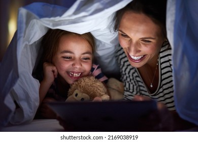 Can we read another one, Mom. Cropped shot of an attractive young woman reading her daughter a bedtime story. - Powered by Shutterstock