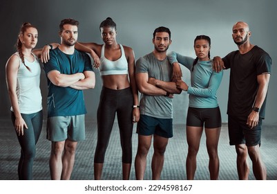 Can you see out muscles. Shot of a group of workout partners together at the gym. - Powered by Shutterstock