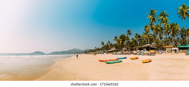 Canacona, Goa, India. Canoe Kayak For Rent Parked On Famous Palolem Beach On Background Tall Palm Tree In Summer Sunny Day.