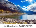 Canada, Alberta, Jasper Park. Lake Medicine. Under Lake Medicine is the longest underground river system in the world. Great autumn day. The sun illuminates the snow-capped mountains