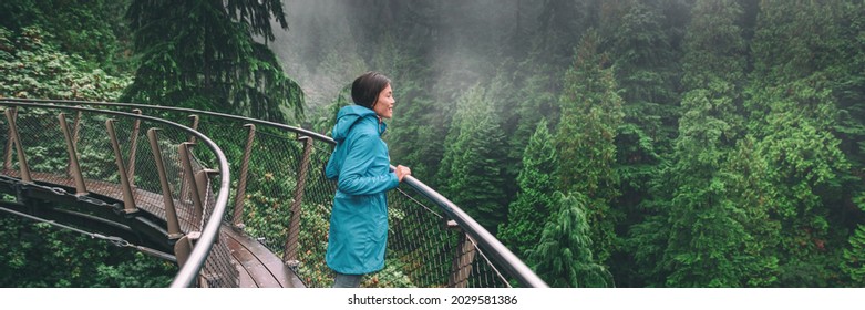 Canada Autumn Travel Destination In British Columbia. Asian Tourist Woman Walking In Famous Attraction Capilano Suspension Bridge Park In North Vancouver. Canadian Vacation Banner.