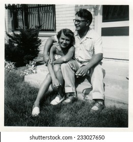 CANADA - CIRCA 1940s: An Antique Photo Shows  Portrait Of A A Young Married Couple In Front Of Their Home.