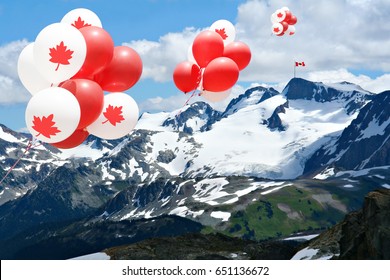 Canada Day Maple Leaf Balloons Floating Over The Rocky Mountains With A Canadian Flag In The Distance.  