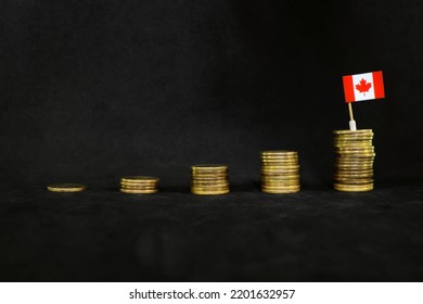 Canada Economic Growth, Recovery After Financial Crisis And Currency Appreciation Concept. Canadian Flag In Increasing Stack Of Coins In Dark Black Background.