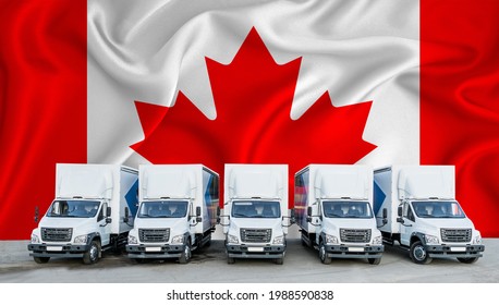 Canada Flag In The Background. Five New White Trucks Are Parked In The Parking Lot. Truck, Transport, Freight Transport. Freight And Logistics Concept